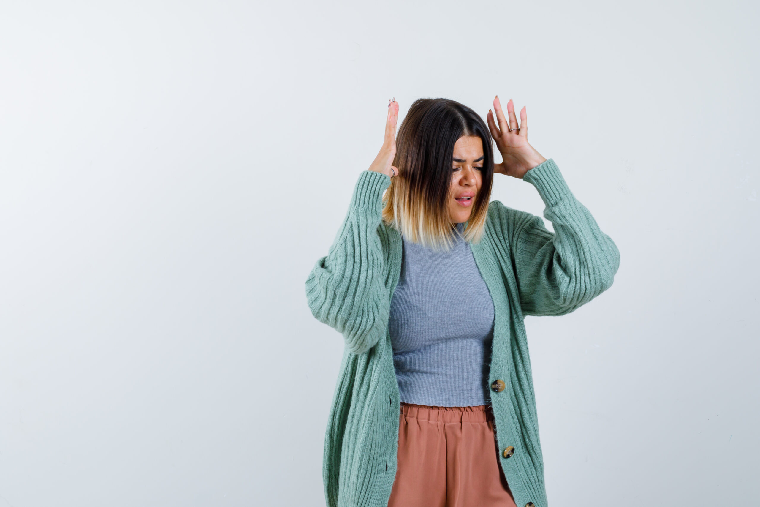 Woman with hands on head showing stress, highlighting stress reduction in the Fertility Reset Blueprint.